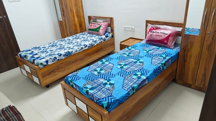 Comfortable double sharing PG room with beds and wardrobe in Pune